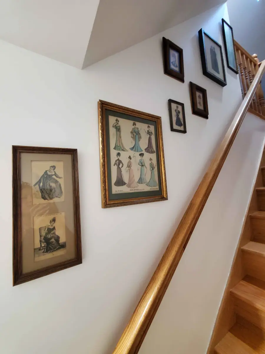 Curated vintage fashion art gallery ascending a classic staircase — designed by Renata Glaz