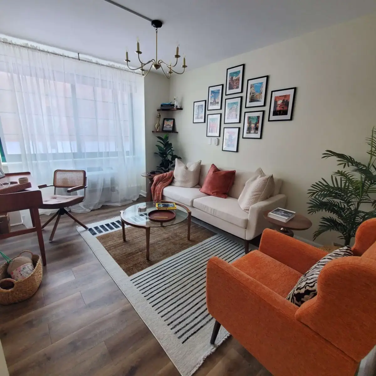 Living room designed by Renata Glaz — gallery wall, mid-century chairs, brass chandelier